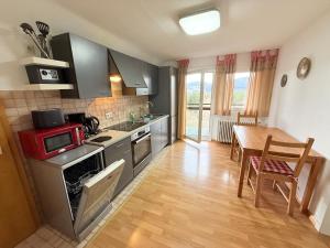 a kitchen with a stove and a table in it at Ferienhaus Frei 3 Budget in Titisee-Neustadt