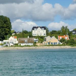 a group of houses on the shore of the water at Beachhouse Humlebæk in Humlebæk +10 photos