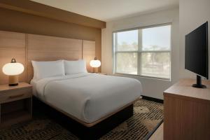 a bedroom with a large bed and a window at Residence Inn Phoenix Mesa in Mesa +35 photos