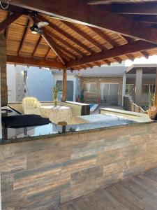 an outdoor patio with a table and a couch at Pousada e Edícula in Jabuticabal