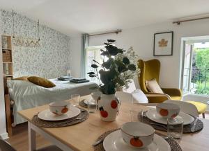 a living room with a table with a vase of flowers at Cocon de douceur en centre ville in Le Puy-en-Velay