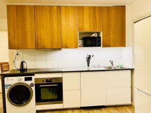 a kitchen with a washer and a microwave at COZY ROOM - between Malmö & Lund in Lund +1 photo