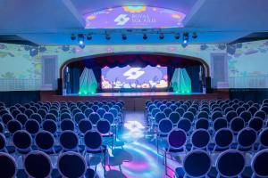 an empty auditorium with blue chairs and a stage at Royal Solaris Los Cabos - All Inclusive in San José del Cabo +57 photos