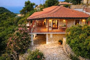 a house with a tile roof and a balcony at Alma-Maroon Klara & Rachel in Drymon