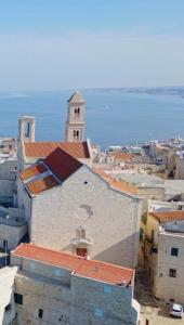 a view of a city with a church and the ocean at Casa del maresciallo in Giovinazzo