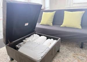 a bed with white pillows in a box at Suite One King Bed 2TVs Free Parking & museums in Richmond
