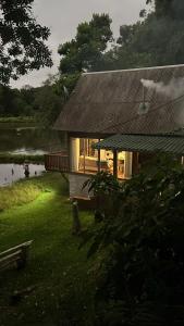 a house with a view of a lake with birds flying at Cabana Gehrke in Nova Petrópolis