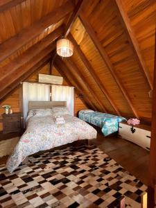 a bedroom with a bed in a attic at Cabana Gehrke in Nova Petrópolis