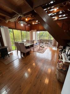 a large living room with a table and chairs at Cabana Gehrke in Nova Petrópolis +50 photos