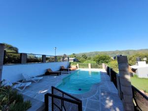 a swimming pool on the roof of a house at Balcones de Bialet in Bialet Massé