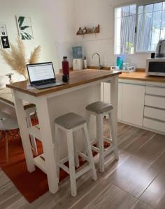 a kitchen island with a laptop computer on top of it at Almaalquiler in Carmen de Patagones