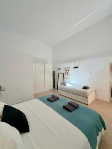 a bedroom with two beds with towels on them at Dama Apartamentos Turísticos Toledo in Toledo +22 photos