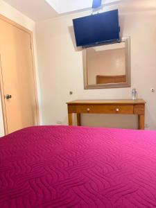 a bedroom with a red bed and a mirror at Hotel Posada de Santiago in Tijuana +14 photos