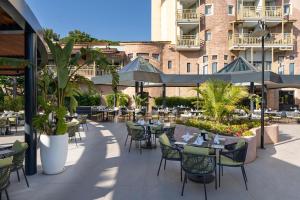 a patio with tables and chairs and a building at Limak Arcadia Sport Resort Belek in Belek