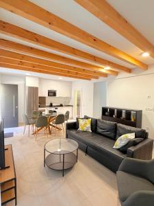a living room with a couch and a table at Dama Apartamentos Turísticos Toledo in Toledo