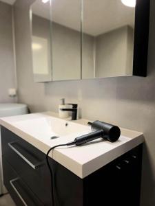 a hair dryer is sitting on a bathroom sink at Fygle living in Vestvågøya +23 photos