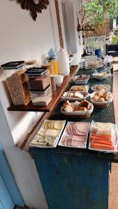 a table with many different types of bread and pastries at Estrela Praia in Fernando de Noronha