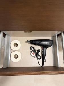 a black hair dryer sitting on top of a shelf at Dama Apartamentos Turísticos Toledo in Toledo
