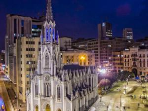 a large white building in a city at night at Piazza Granada in Cali
