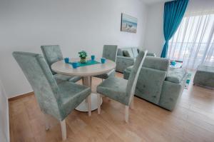 a living room with a table and chairs and a couch at Mir i More in Dobra Voda