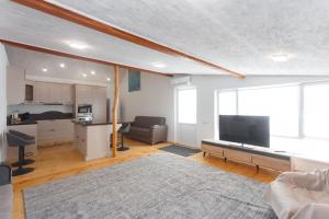 a living room with a large flat screen tv at HomeRent Bucuresti Studio in Chişinău
