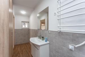 a bathroom with a sink and a mirror at HomeRent Bucuresti Studio in Chişinău +10 photos