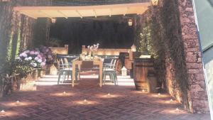 a patio with a table and chairs and a building at Dimora ANETT B&B HOUSE in Codevigo