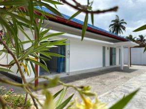 a white house with a red roof at Andrella Rest House in Mannar