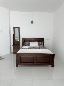 a large bed in a room with a mirror at Andrella Rest House in Mannar +15 photos