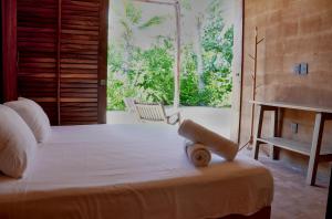 a bedroom with a large bed and a window at Mazul Puerto Escondido in Tlachicón +128 photos