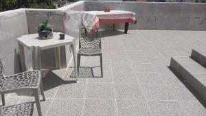 a patio with a table and two chairs and a table and a table at Flat vista mar in Paulista