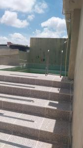 a set of stairs leading to a swimming pool at Flat vista mar in Paulista