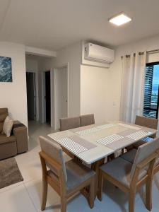 a dining room with a table and chairs at Ocean View • Swimming Pool and Jacuzzi in Penha