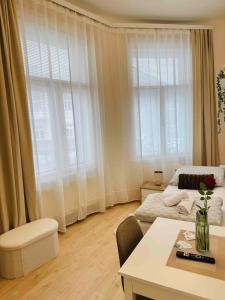 a living room with a bed and a table at Ostrava Apartment in Ostrava