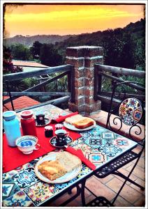 a table with food on top of a balcony at La Fonte e l Ulivo in Ripatransone