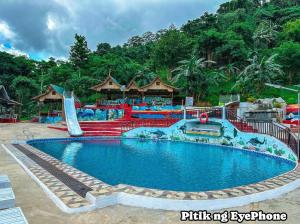 a pool at a resort with a water park at Manga's swimming pool in El Nido Airport