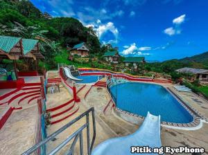 a swimming pool at a resort with a slide at Manga's swimming pool in El Nido Airport