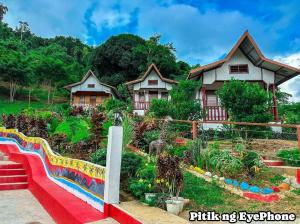 a garden in front of a house at Manga's swimming pool in El Nido Airport