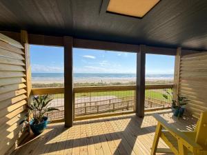 a screened in porch with a view of the beach at The Breeze Beachfront Resort in Surfside Beach