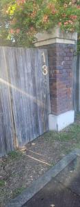 a wooden fence with a bicycle sign on it at Aztec Adress 133 Beckett Road, mixed shared accommodation in Brisbane