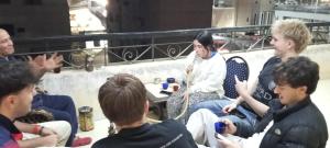a group of people sitting around each other at Pyramids Heritage suites in Ghaţāţī