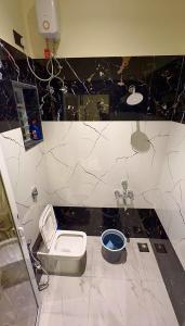 a bathroom with a toilet and a sink at Aarambh Villa in Sātirje +5 photos