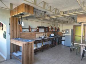 a large kitchen with a counter and a refrigerator at Hostel Eco Punta Cana in Punta Cana