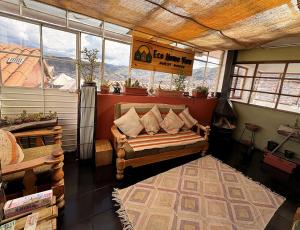 a room with a couch in a room with windows at Eco Home View - Guest House in Cusco