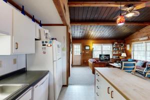 a kitchen with a white refrigerator and a living room at AV054 Blue Dolphin in Avon