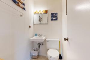 a white bathroom with a toilet and a sink at AV054 Blue Dolphin in Avon +27 photos