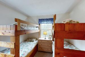 a bedroom with two bunk beds and a window at AV054 Blue Dolphin in Avon
