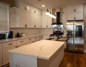 a kitchen with white cabinets and a marble counter top at 4BR5BA Luxury World Cup hub in North Bergen