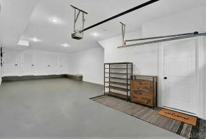 an empty garage with white walls and white cabinets at 4BR5BA Luxury World Cup hub in North Bergen