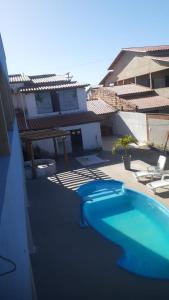 a swimming pool on the side of a building at Pousada Sol e Mar in Saubara